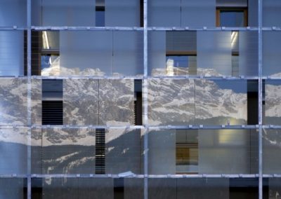 cube hotel glass facade reflecting mountains
